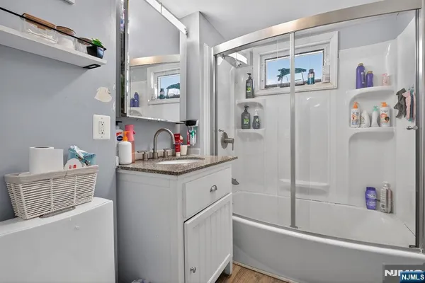 a bathroom with a sink a mirror and a shower