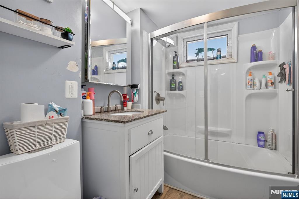 229 Patterson Street Harrison, NJ 07029 - Photo 17 of 25 a bathroom with a sink a mirror and a shower