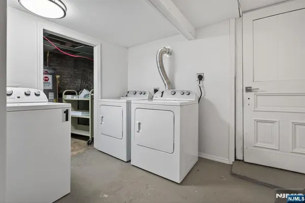 a view of washer and dryer with bathroom