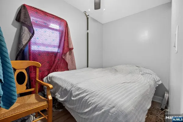 a bedroom with a bed and teddy bear on bed