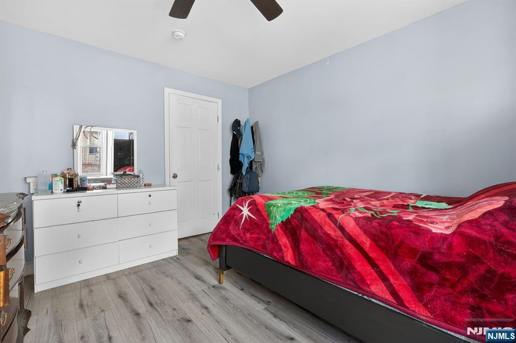 229 Patterson Street Harrison, NJ 07029 - Photo 7 of 25 a bedroom with a bed and a mirror