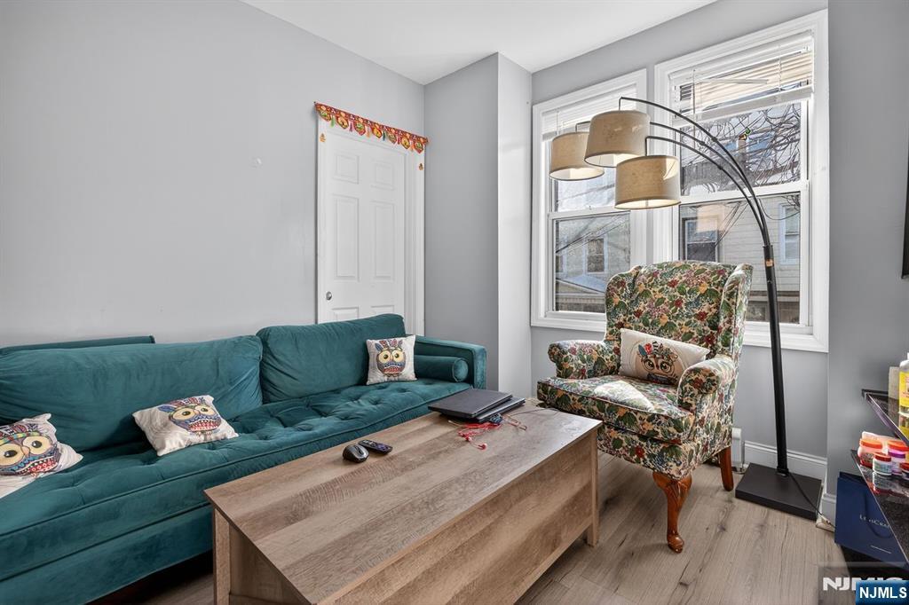 229 Patterson Street Harrison, NJ 07029 - Photo 8 of 25 a living room with furniture and a window