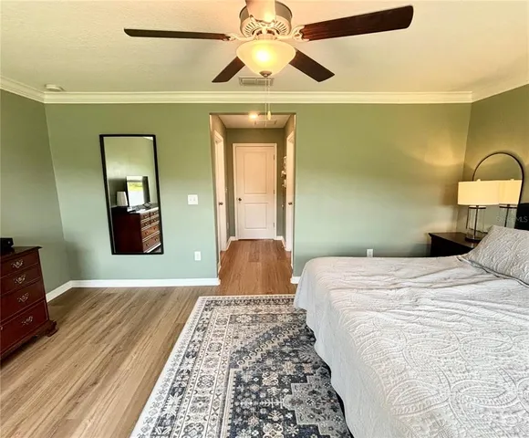 a bedroom with a bed and a lamp