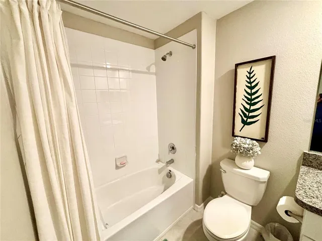 a bathroom with a toilet and a bathtub