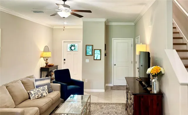 a living room with furniture and a chandelier