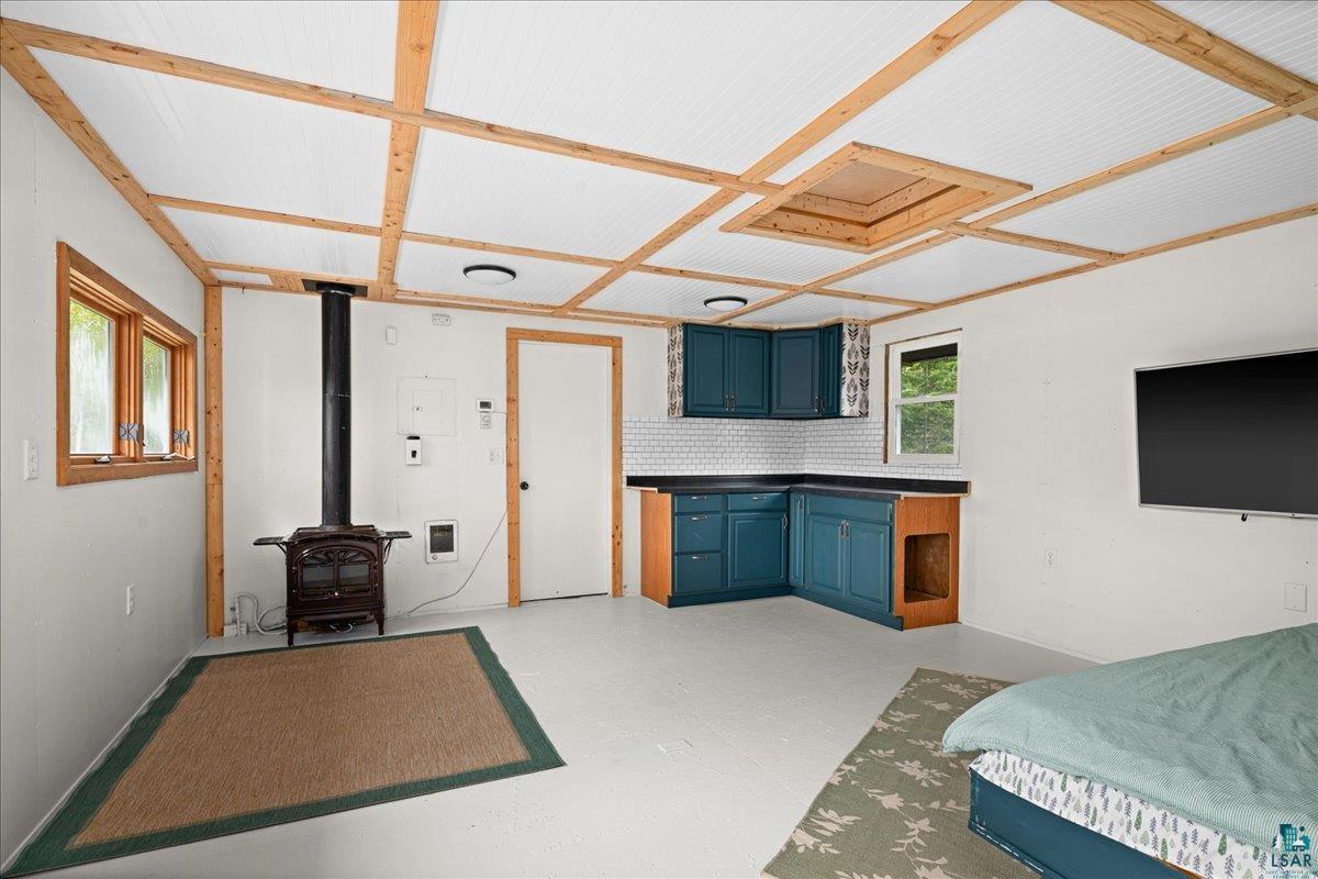 5923 North Shore Drive Duluth, MN 55804 - Photo 19 of 38 Bedroom featuring a wood stove and light flooring