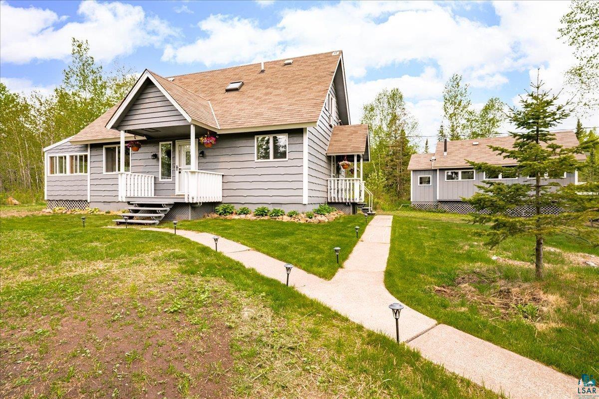 5923 North Shore Drive Duluth, MN 55804 - Photo 25 of 38 View of front of home featuring covered porch, a front yard, and roof with shingles