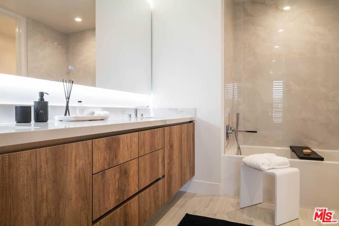 411 South Hamel Road, Unit 401 Los Angeles, CA 90048 - Photo 11 of 19 a bathroom with a sink and a mirror