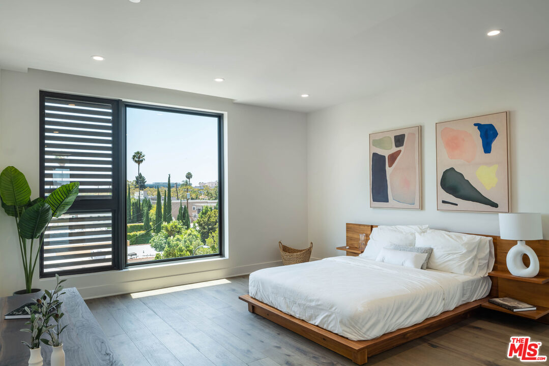 411 South Hamel Road, Unit 401 Los Angeles, CA 90048 - Photo 12 of 19 a bedroom with a large bed and a large window