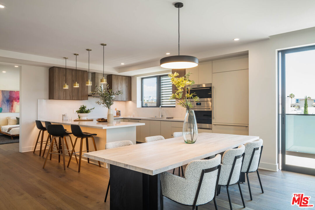 411 South Hamel Road, Unit 401 Los Angeles, CA 90048 - Photo 5 of 19 a view of a dining room and livingroom with furniture wooden floor a chandelier