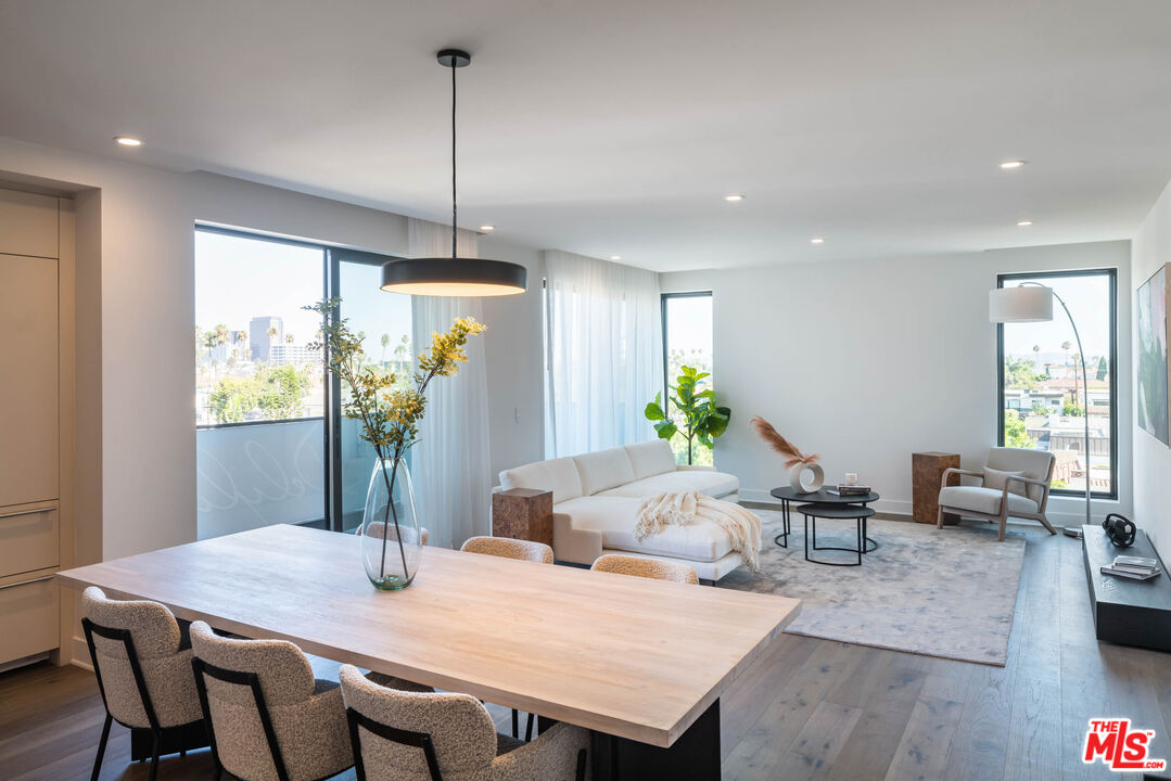 411 South Hamel Road, Unit 401 Los Angeles, CA 90048 - Photo 6 of 19 a view of a dining room with furniture window and wooden floor