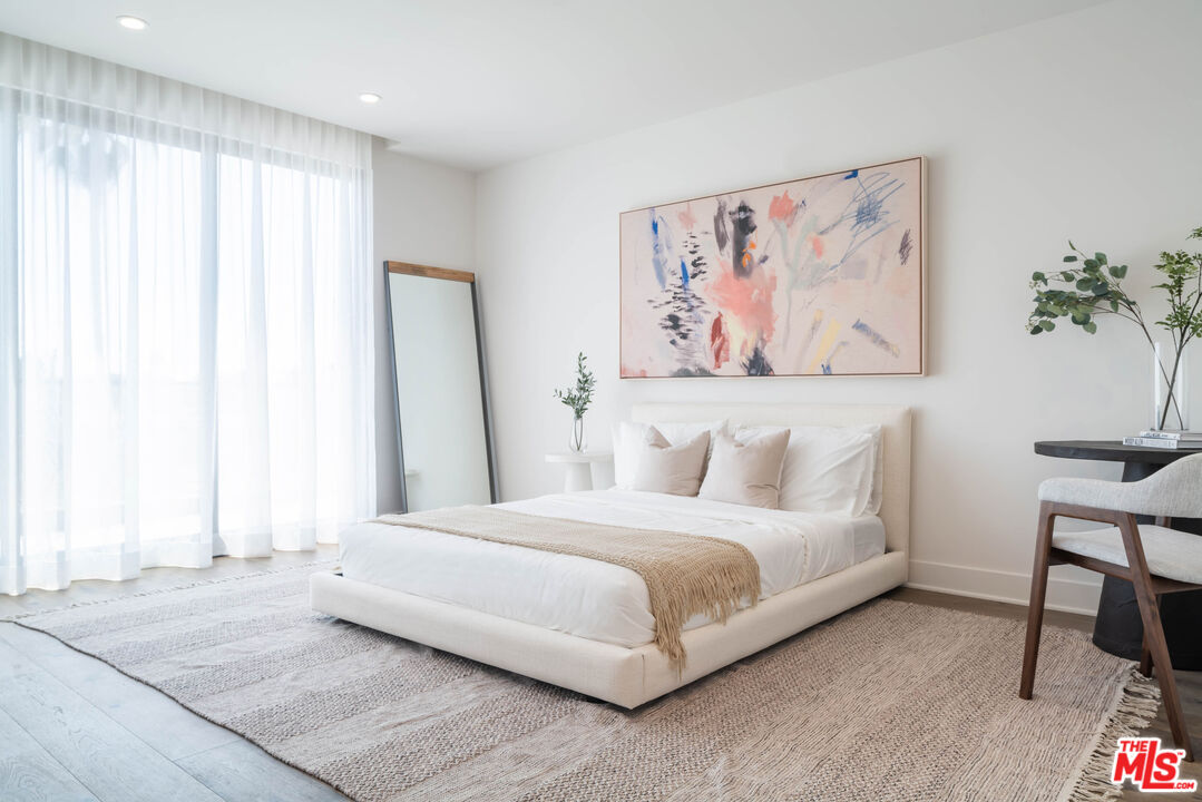 411 South Hamel Road, Unit 401 Los Angeles, CA 90048 - Photo 9 of 19 a bedroom with a bed and a painting on the wall