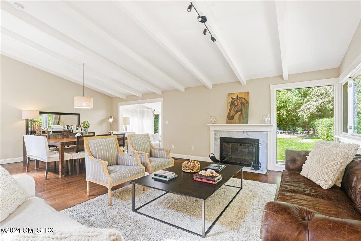 70 Gregory Road Cos Cob, CT 06807 - Photo 5 of 39 a living room with furniture fireplace and a large window