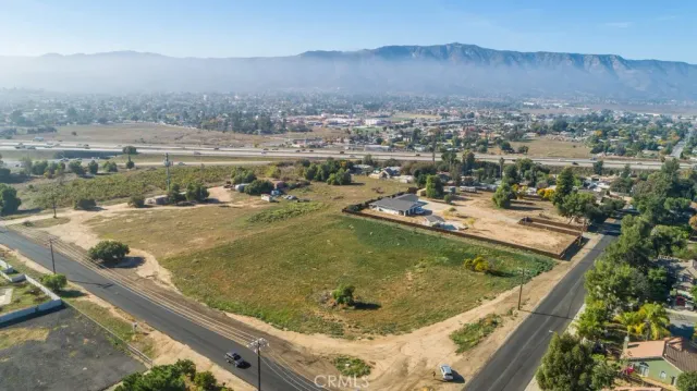 an aerial view of residential houses with outdoor space and seating