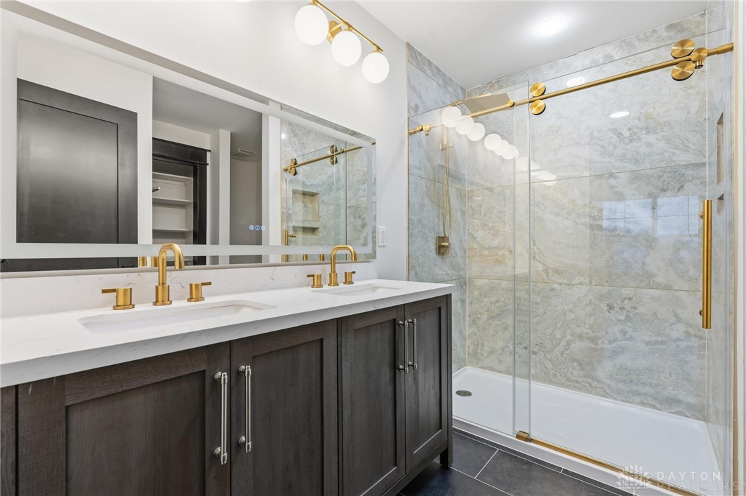3509 South State Rte 72 Sabina, OH 45169 - Photo 28 of 44 Elegant primary bathroom featuring a double vanity and a spacious, glass-enclosed shower.