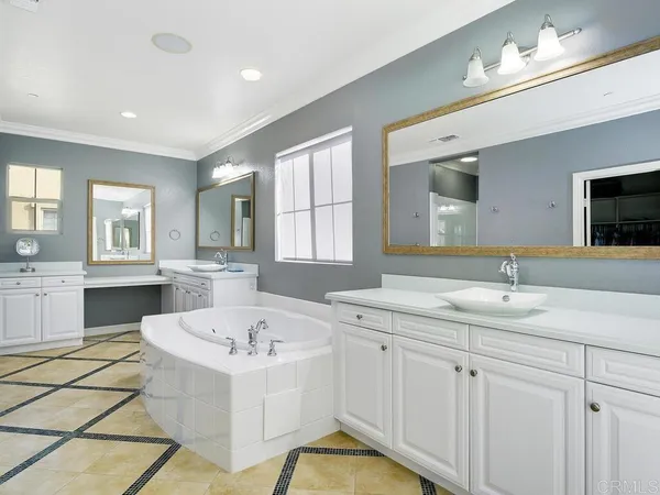 a bathroom with a sink a bathtub a mirror and a shower