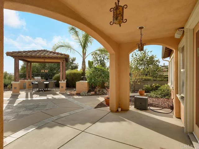 a view of a porch with dining table and chairs