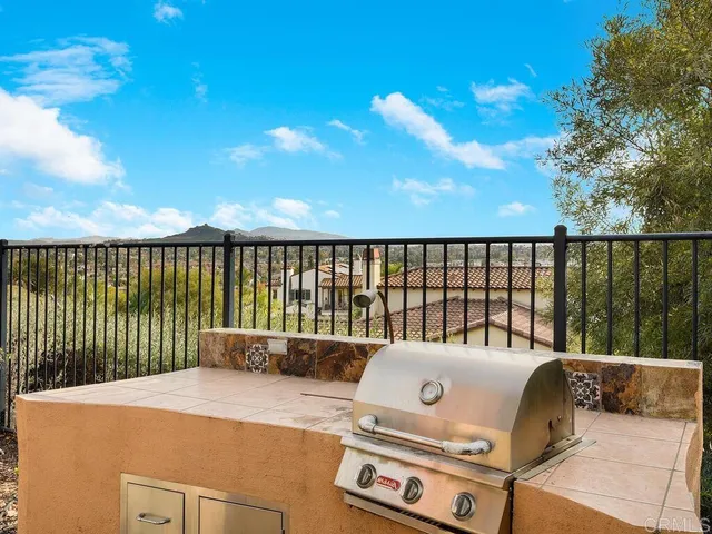 a roof deck with a table under an umbrella