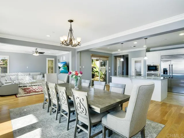 a dining room with furniture a rug and a chandelier