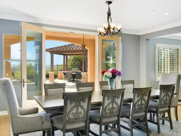 a view of a dining room with furniture large windows and wooden floor