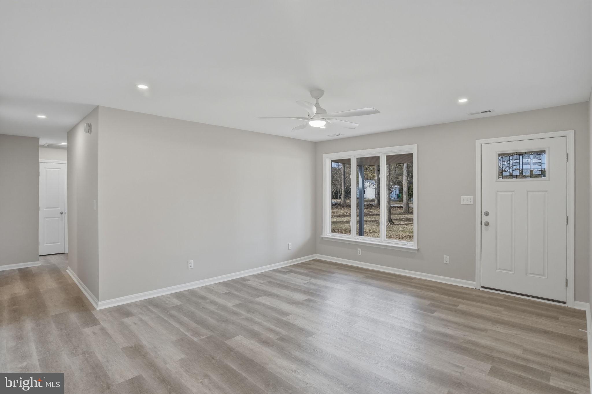 3250 Andrews Lake Road Felton, DE 19943 - Photo 12 of 45 a view of an empty room with wooden floor and a window