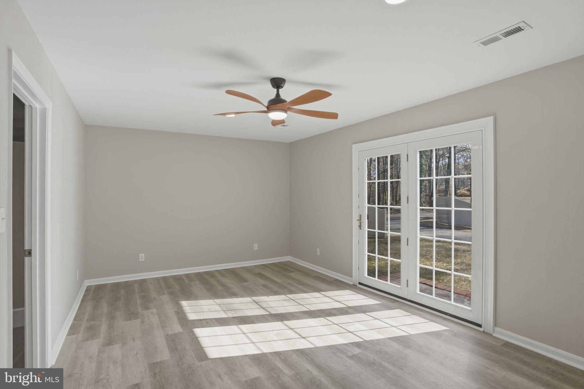 3250 Andrews Lake Road Felton, DE 19943 - Photo 16 of 45 a view of an empty room with a window and a ceiling fan