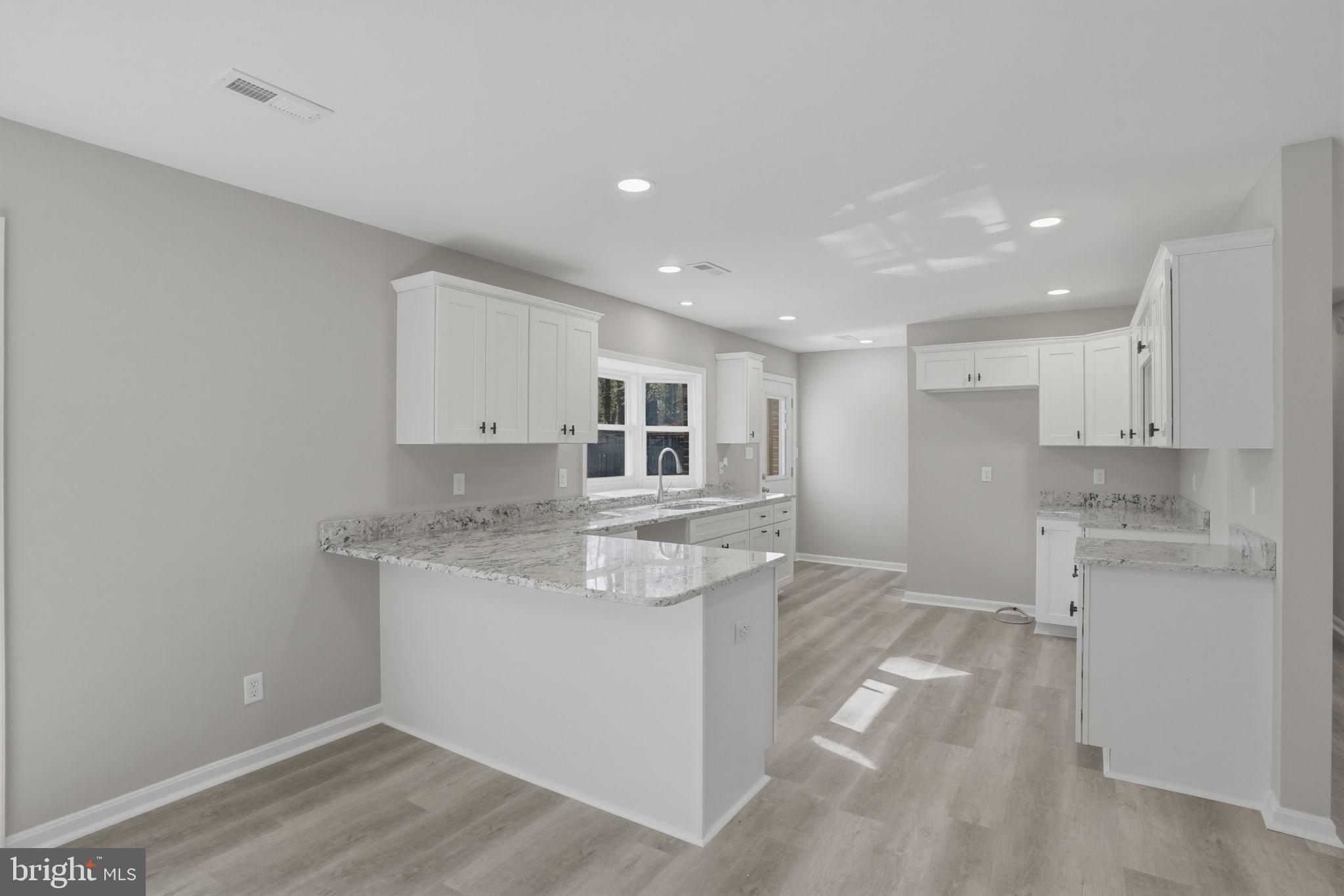 3250 Andrews Lake Road Felton, DE 19943 - Photo 17 of 45 a kitchen with stainless steel appliances granite countertop a sink and cabinets