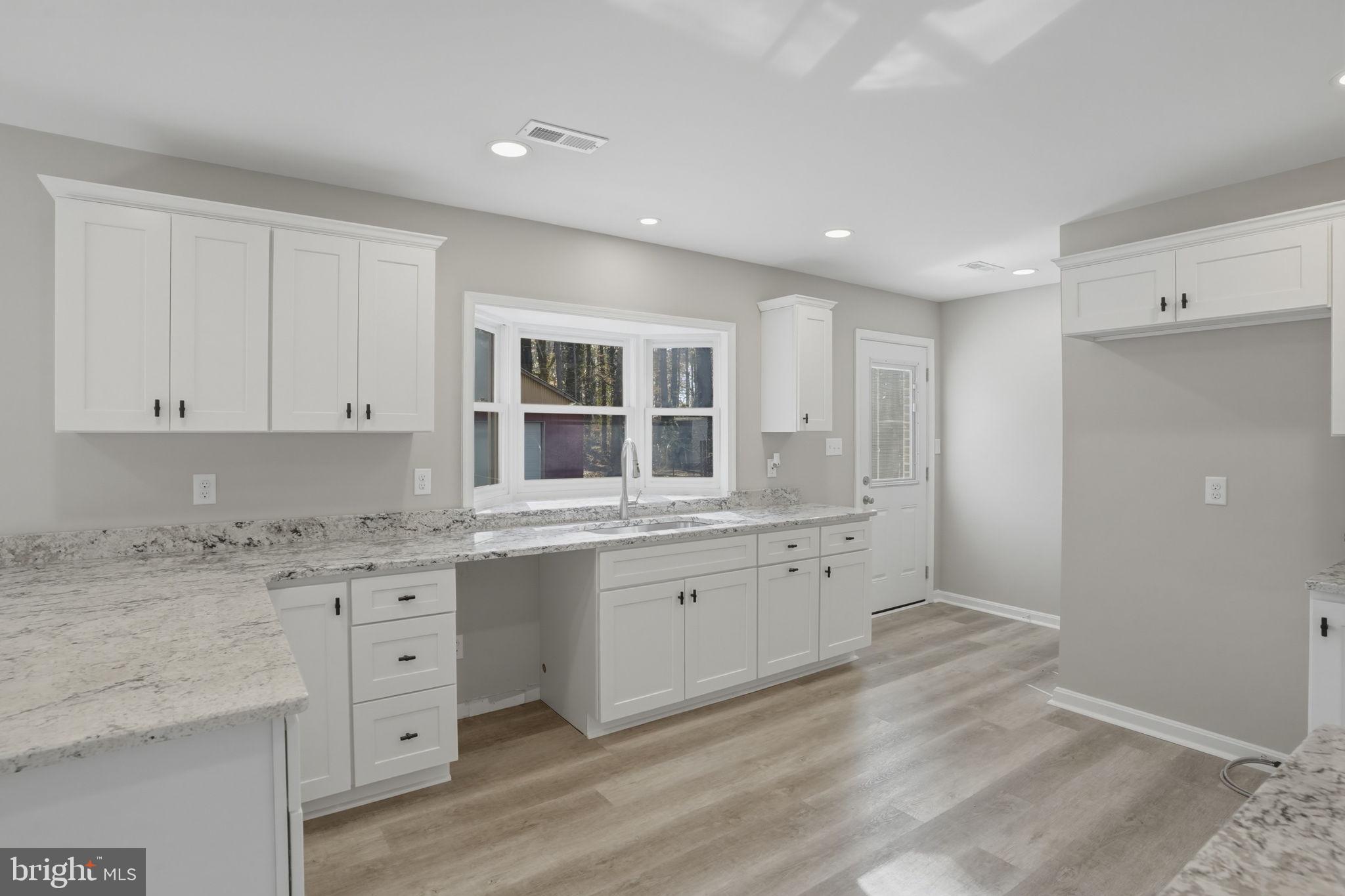 3250 Andrews Lake Road Felton, DE 19943 - Photo 18 of 45 a large bathroom with a granite countertop sink and a large mirror