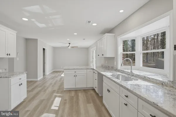 a large kitchen with a lot of counter space and a sink