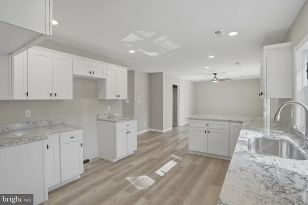 a kitchen with a sink stove and cabinets