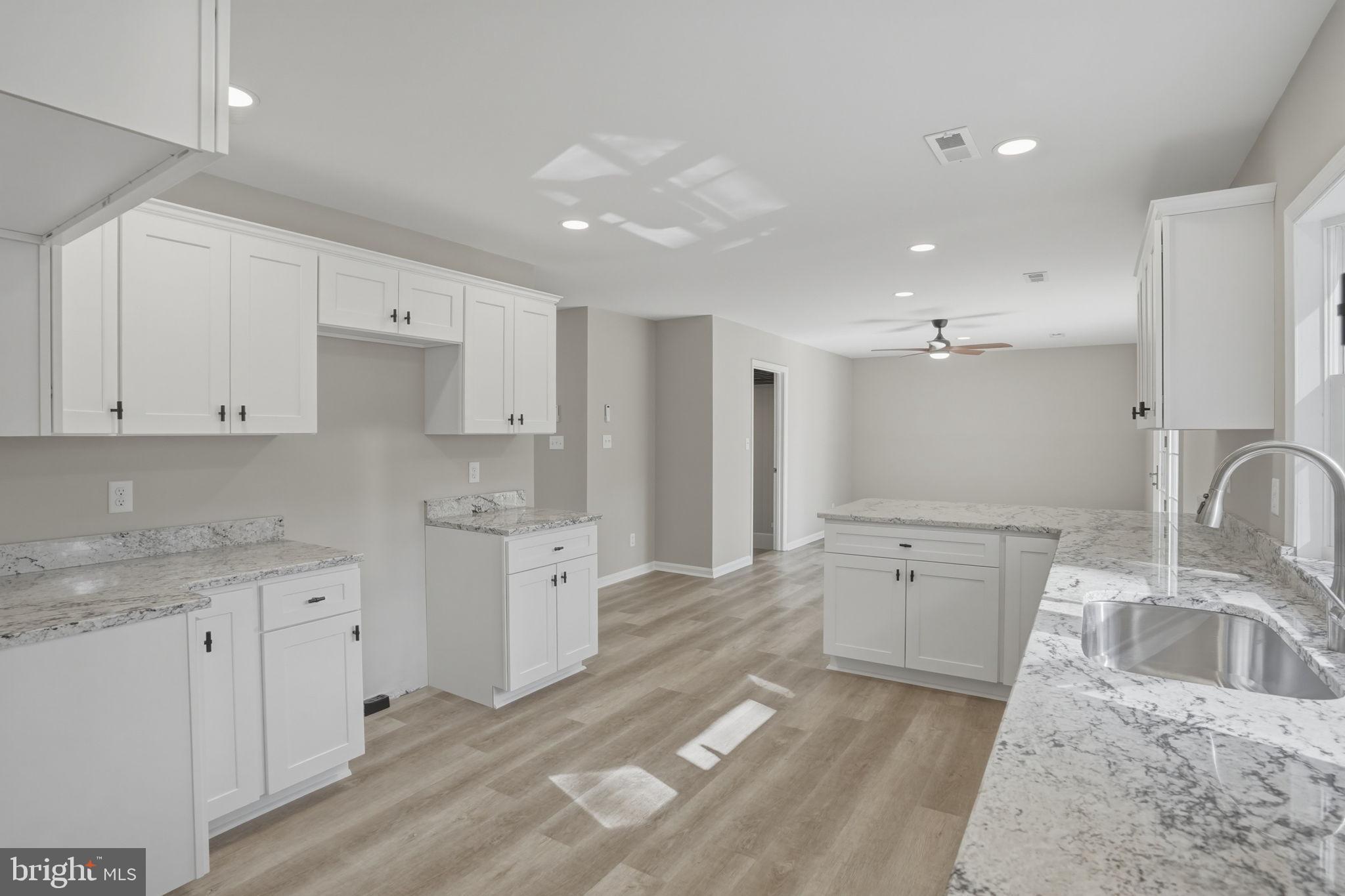 3250 Andrews Lake Road Felton, DE 19943 - Photo 21 of 45 a large kitchen with a lot of counter space and a sink