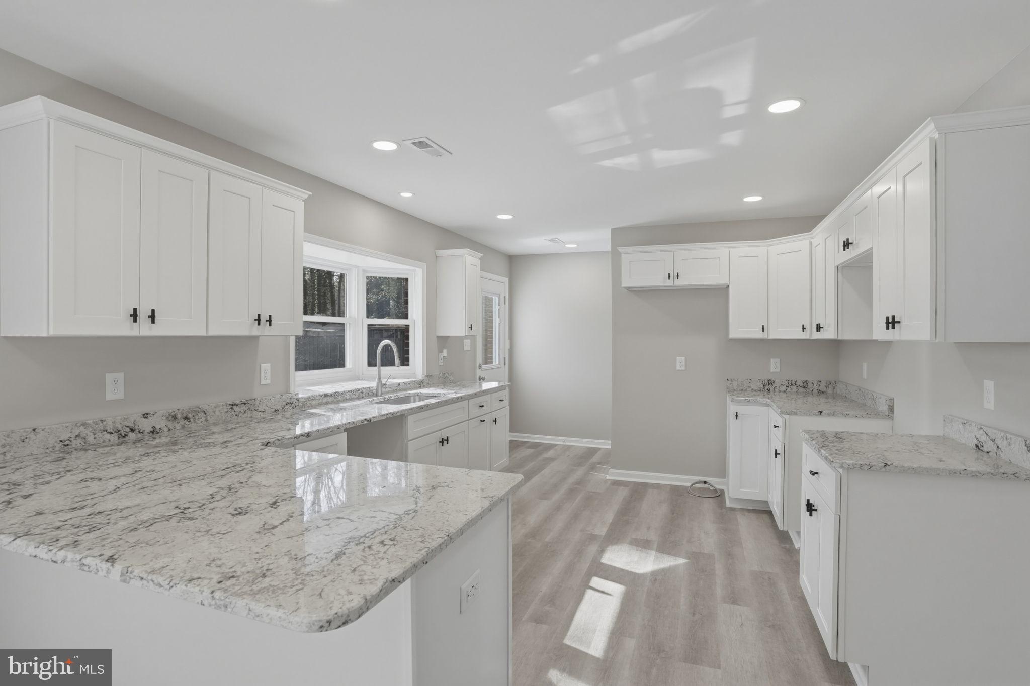 3250 Andrews Lake Road Felton, DE 19943 - Photo 22 of 45 a kitchen with a sink stove and cabinets