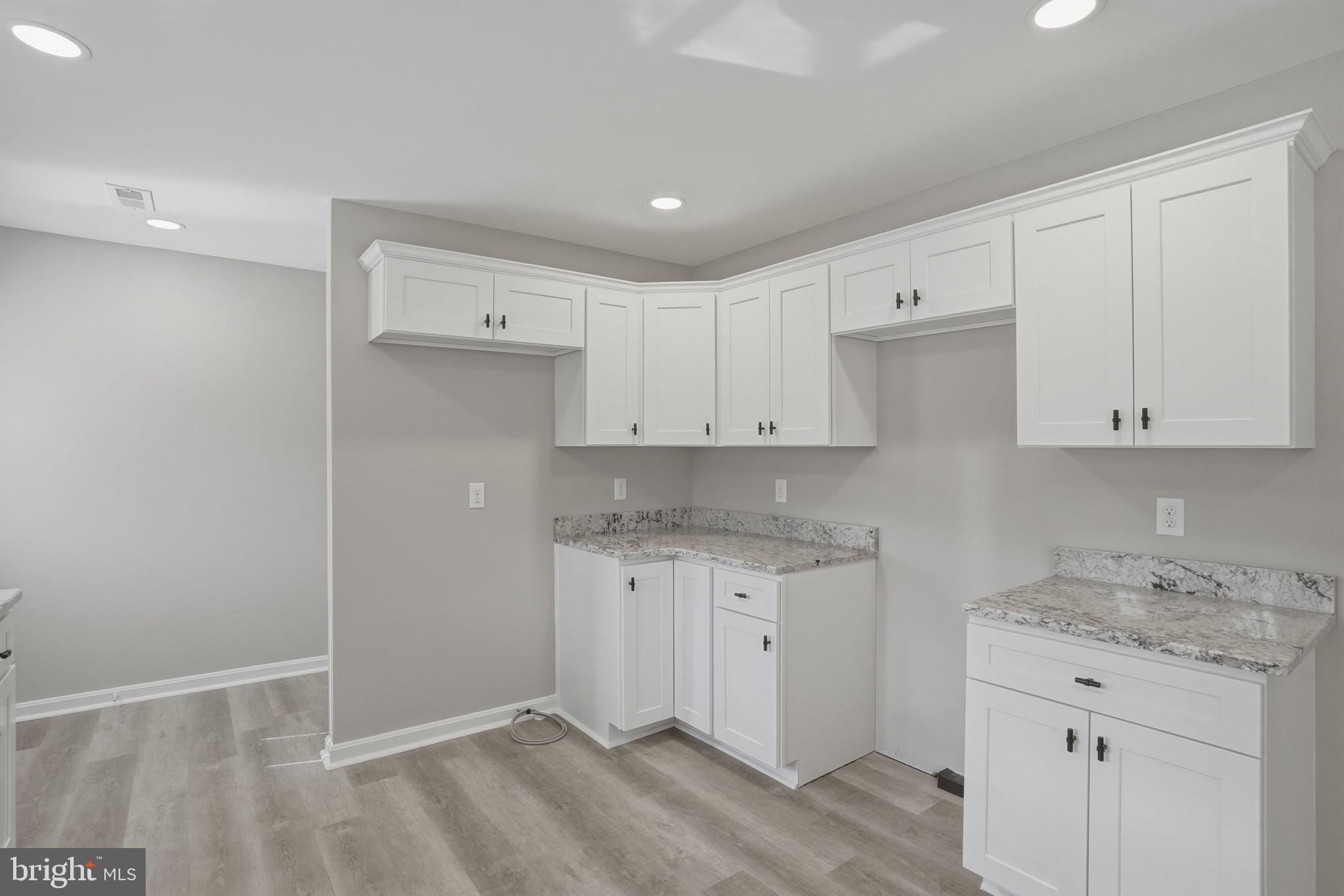3250 Andrews Lake Road Felton, DE 19943 - Photo 23 of 45 a kitchen with granite countertop a sink and white cabinets