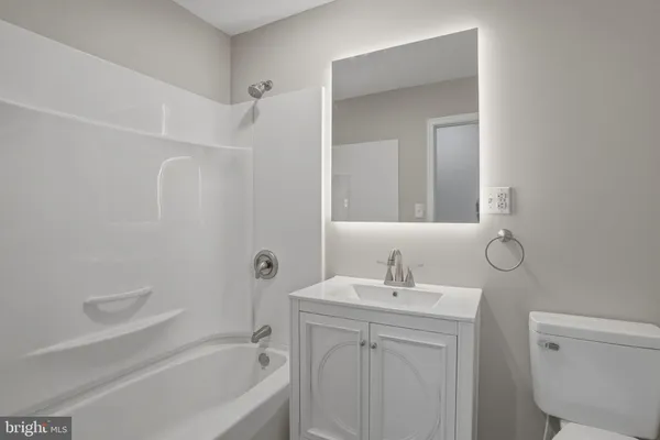 an empty room with a ceiling fan and a window