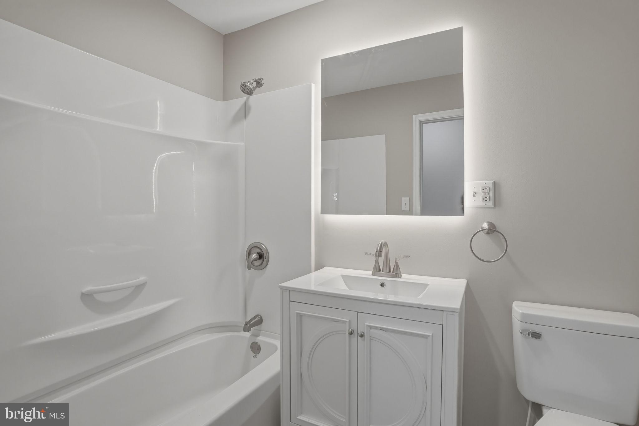 3250 Andrews Lake Road Felton, DE 19943 - Photo 26 of 45 a bathroom with a bathtub shower sink vanity and toilet