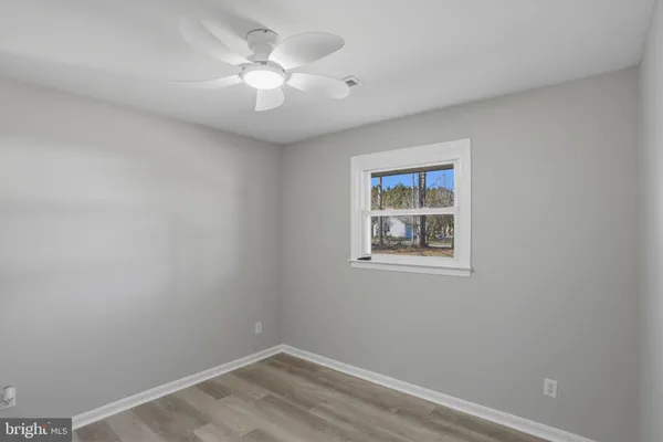 a view of a room with a fan and a fan