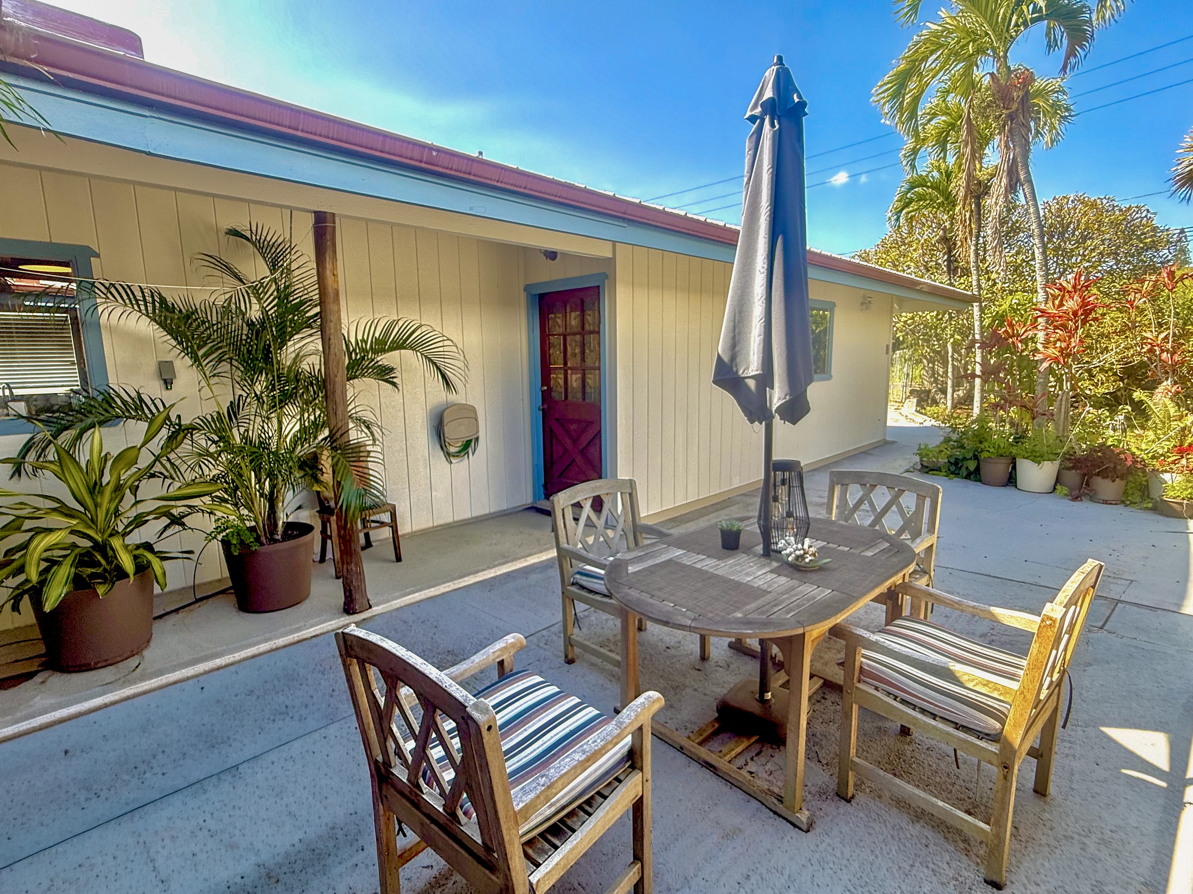 94-1726 Wakea Avenue Naalehu, HI 96772 - Photo 1 of 30 a backyard of a house with barbeque oven table and chairs