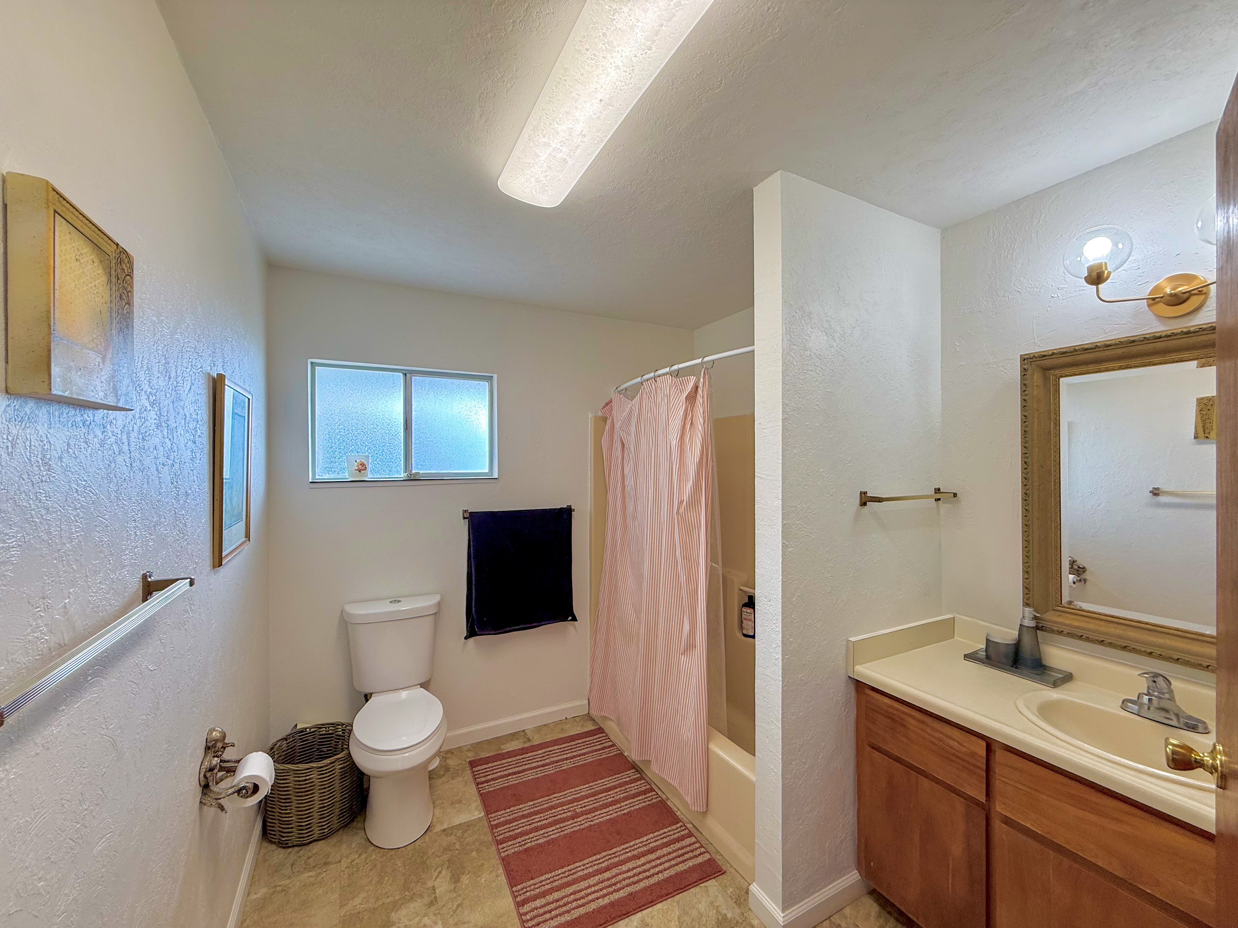 94-1726 Wakea Avenue Naalehu, HI 96772 - Photo 13 of 30 a bathroom with a sink toilet and shower