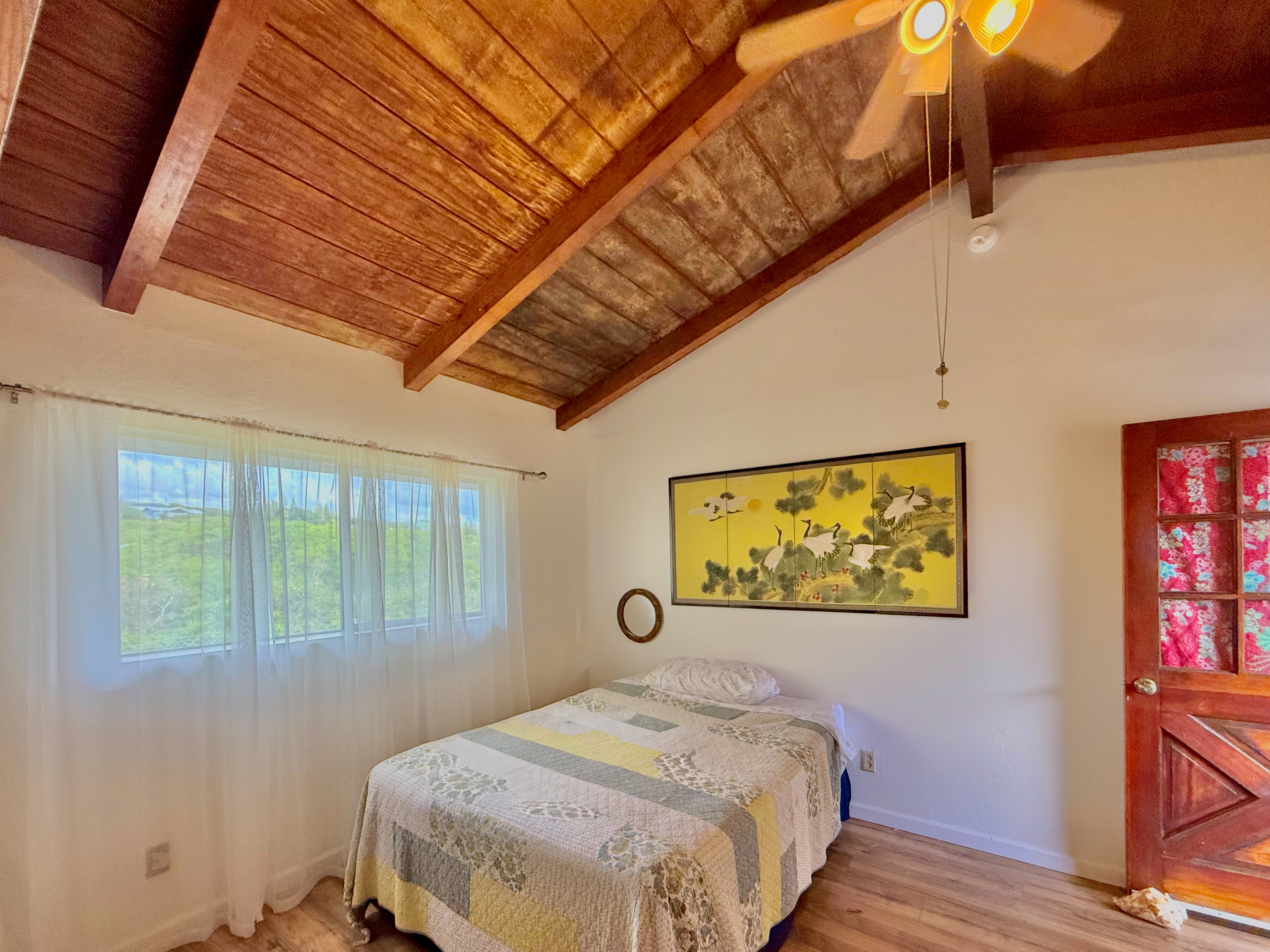 94-1726 Wakea Avenue Naalehu, HI 96772 - Photo 16 of 30 a bedroom with a bed and a window