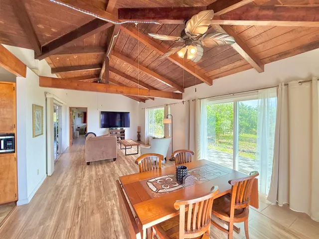 a dining room with furniture and wooden floor