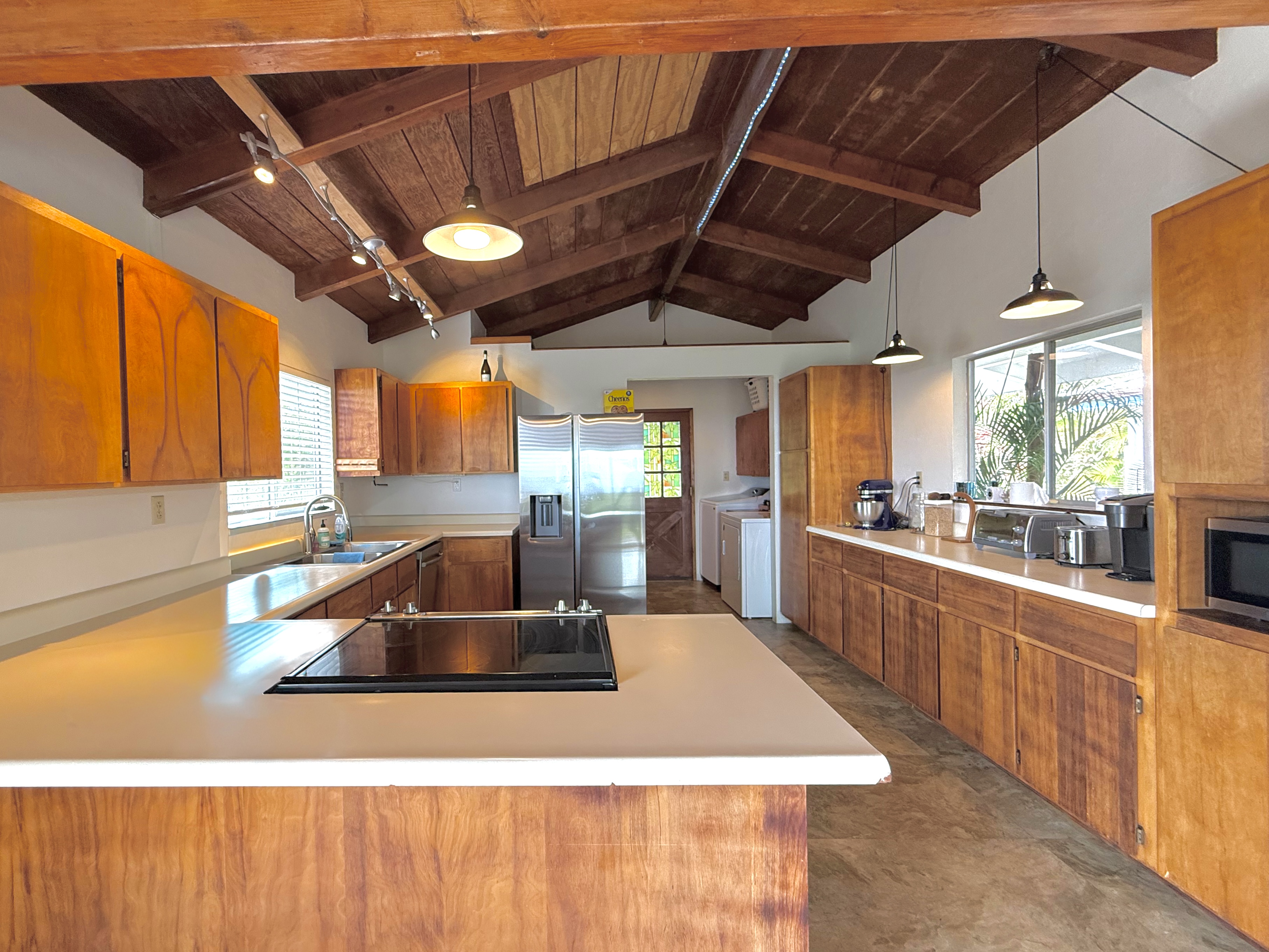 94-1726 Wakea Avenue Naalehu, HI 96772 - Photo 8 of 30 a kitchen with stainless steel appliances granite countertop a sink a counter space and a window
