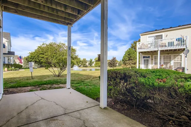 a view of a house with backyard and porch