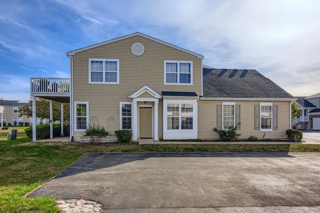a front view of a house with lots of trees