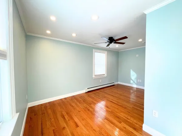 a view of a livingroom with a ceiling fan and window