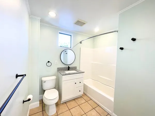 a bathroom with a sink toilet a mirror and shower