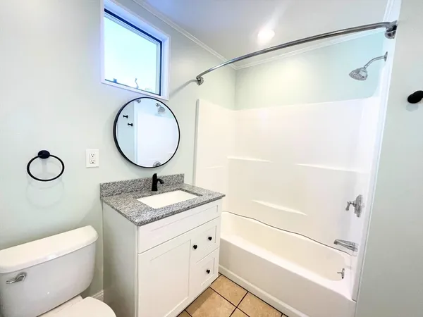 a bathroom with a granite countertop sink toilet and a mirror