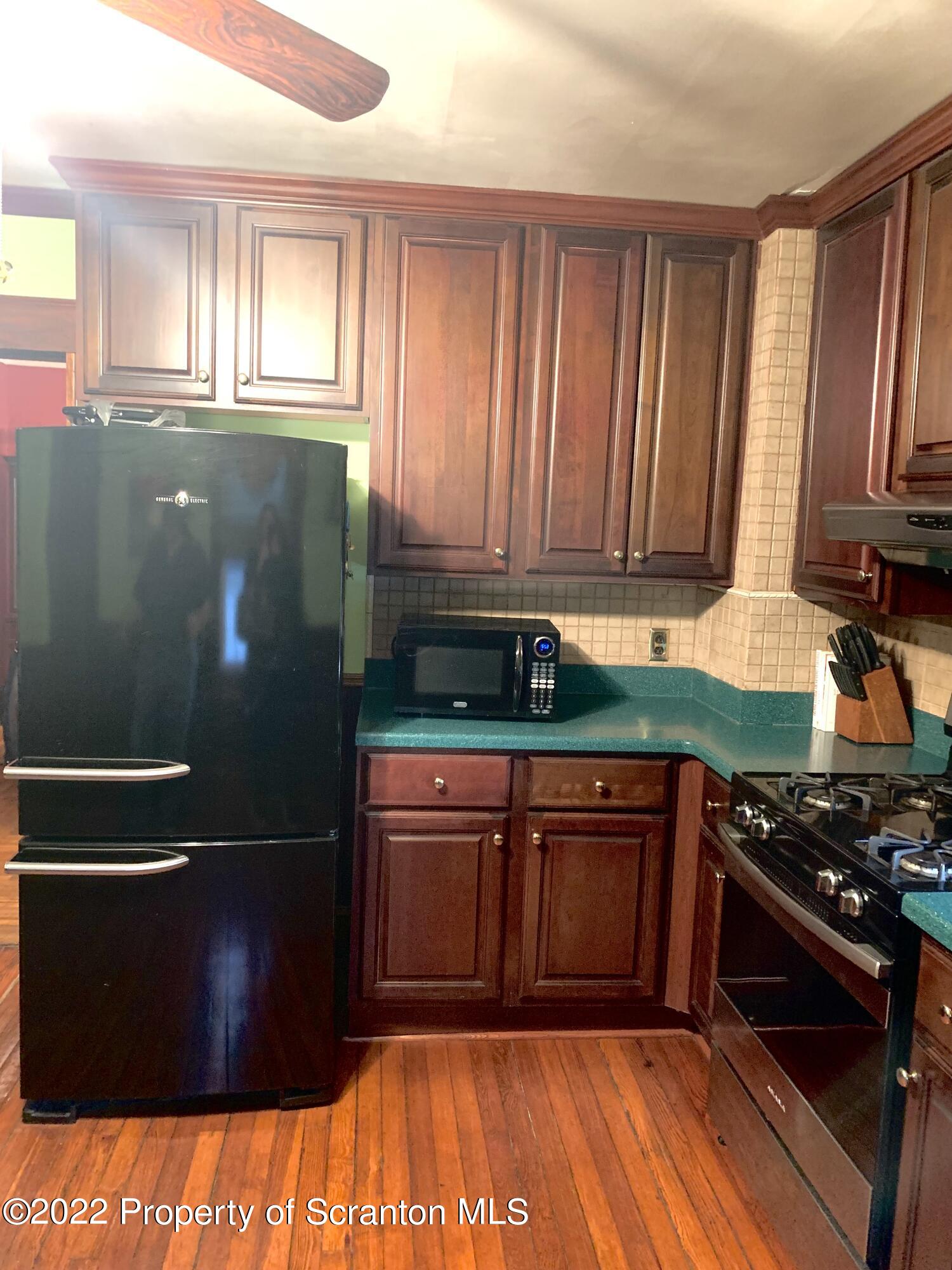 2002 Rigg Street Dunmore, PA 18512 - Photo 8 of 29 a kitchen with wooden cabinets