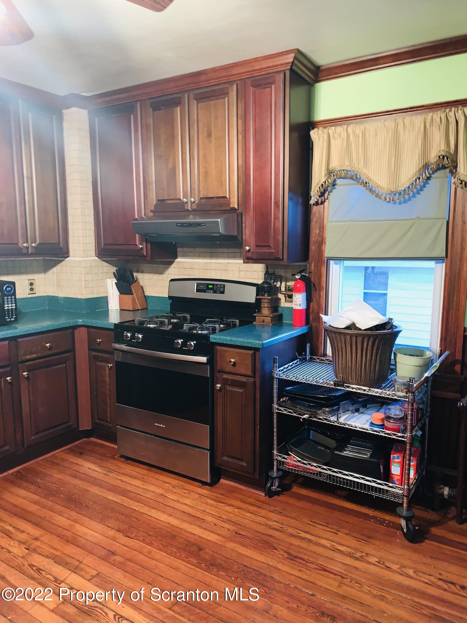2002 Rigg Street Dunmore, PA 18512 - Photo 9 of 29 a kitchen with stainless steel appliances granite countertop a stove a sink and a microwave