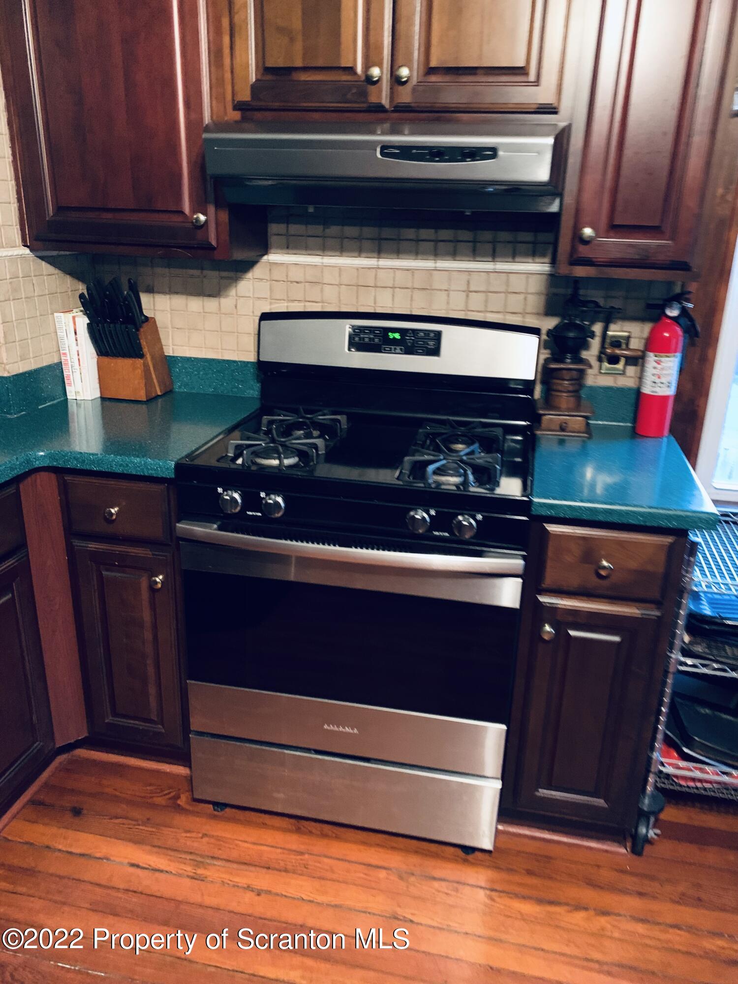 2002 Rigg Street Dunmore, PA 18512 - Photo 10 of 29 a kitchen with stainless steel appliances granite countertop a stove and a microwave