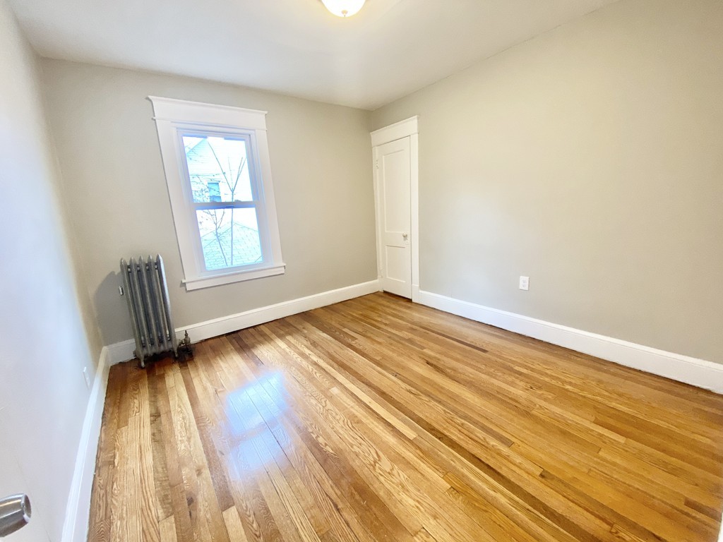 12-14 Howes Street Springfield, MA 01118 - Photo 29 of 35 an empty room with wooden floor and windows